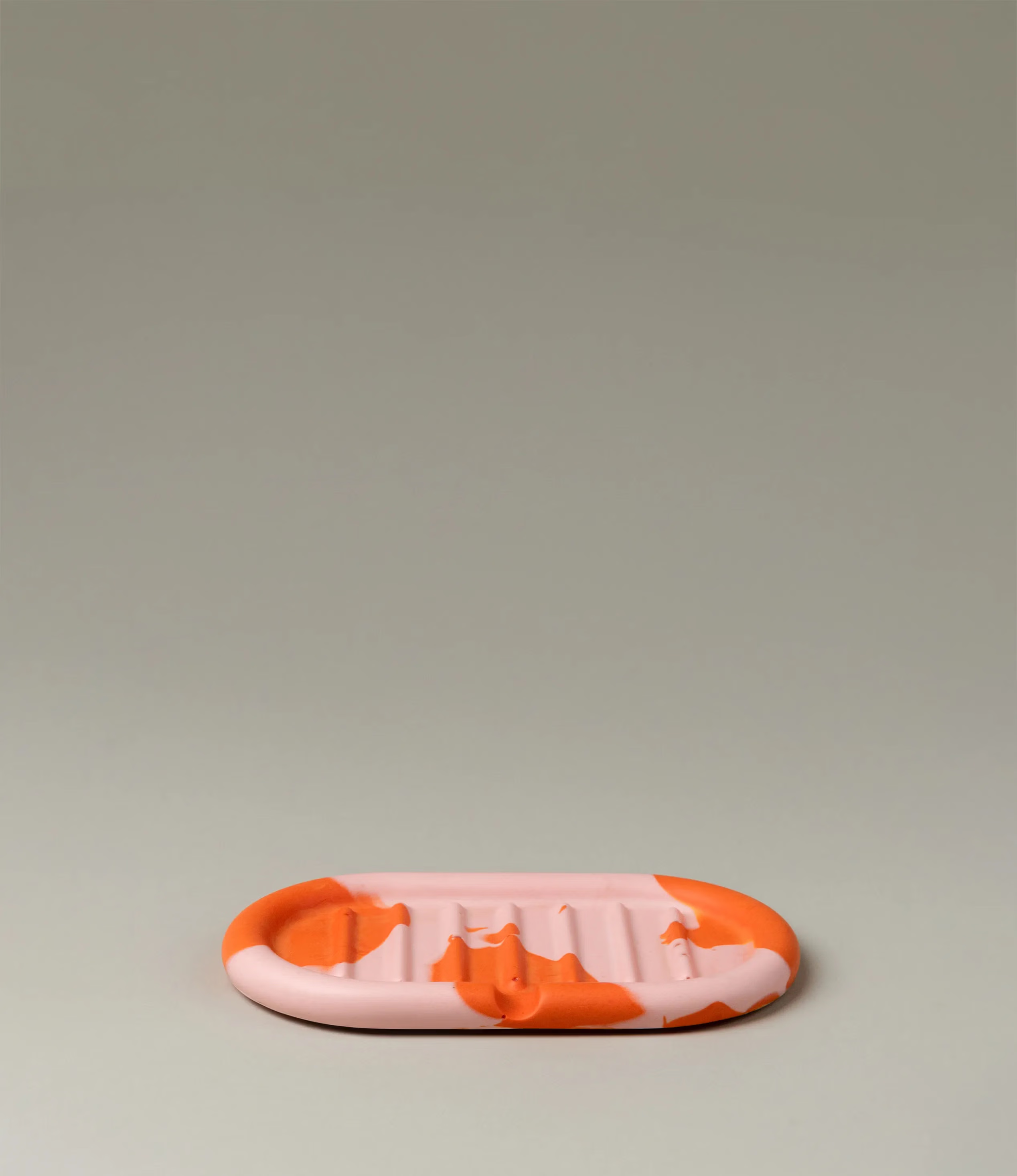 Soap Holder from Gritful Homeware in the maximalist color pairing of light rose and orange. The soap dish has a rounded shape which matches the pattern of the item, which is very much organic. 